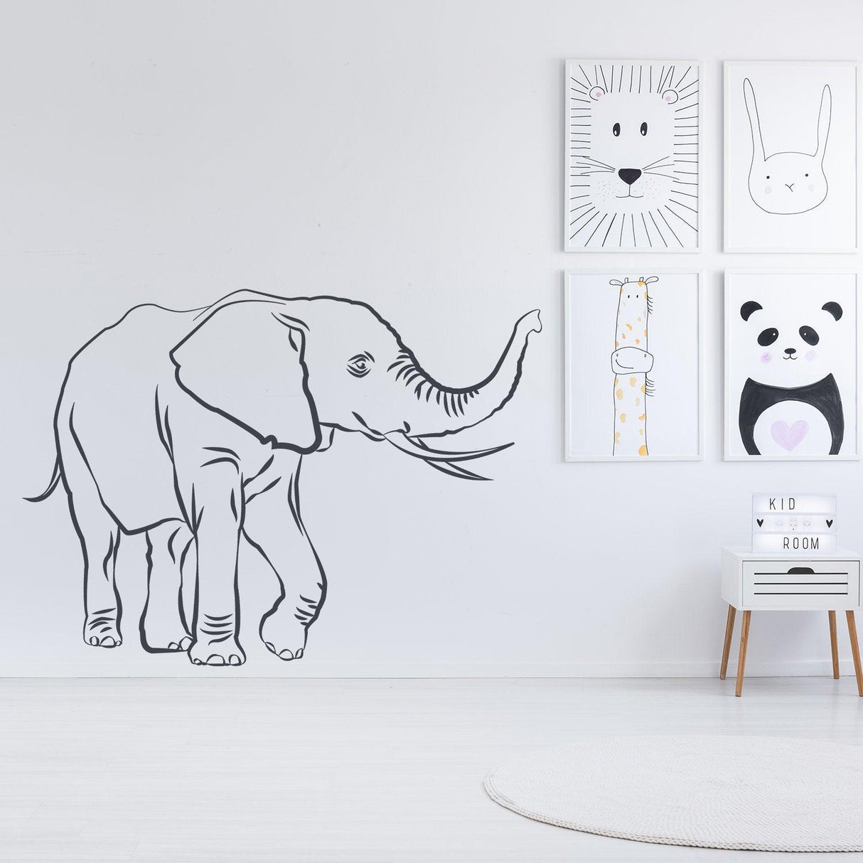 Charming elephant vinyl wall decal, perfect for kids' room decor, adds whimsy and cuteness to any space.
