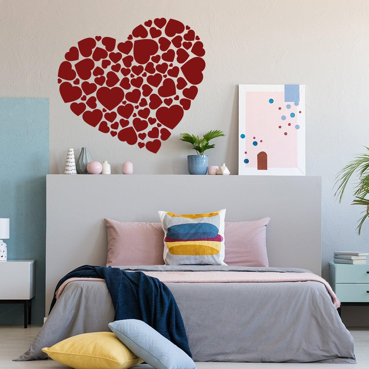 Heart sticker art vinyl decal in a cozy bedroom setting, featuring a large heart made of mini heart shapes.