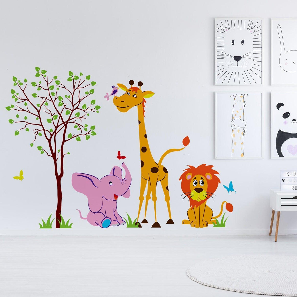 Colorful nursery animal wall decor featuring a giraffe, elephant, and lion with butterflies and trees.