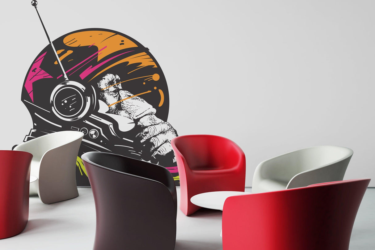 Astronaut space monkey wall vinyl sticker art in a modern lounge setting with colorful chairs.