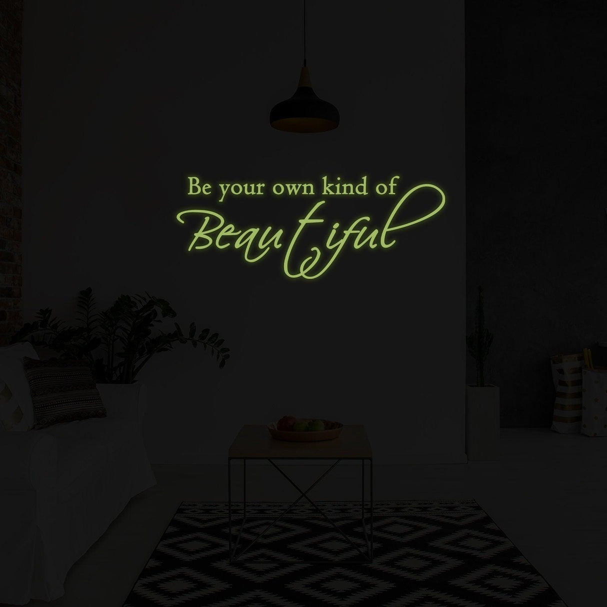 Glow in dark wall sticker with the quote 'Be your own kind of Beautiful' illuminating a stylish room.