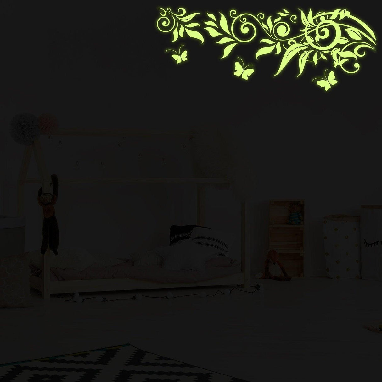 Glow at Night Decal Branch Wall Sticker with glowing flowers and butterflies in a kids' bedroom setting.