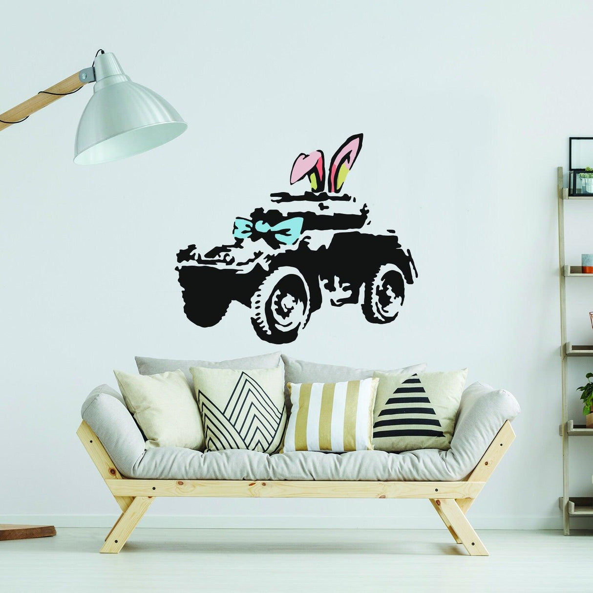 Banksy armoured car wall art sticker with bunny ears and bow, adding urban style to modern decor.