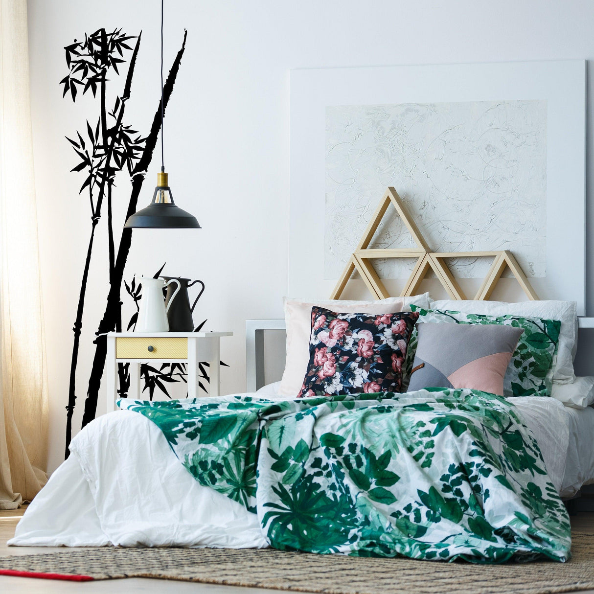 Bamboo wall vinyl sticker in bedroom decor, featuring green bedding and stylish decorations.