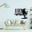 Banksy Leopard Barcode Wall Sticker on a living room wall above a modern couch with decorative pillows.