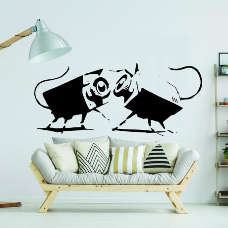 Banksy-style wall art featuring playful mice in black and white on a modern living room wall.