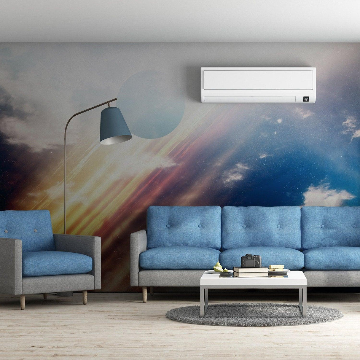 Modern living room with blue sofas and a stunning outer space wall mural featuring galaxies and planets.