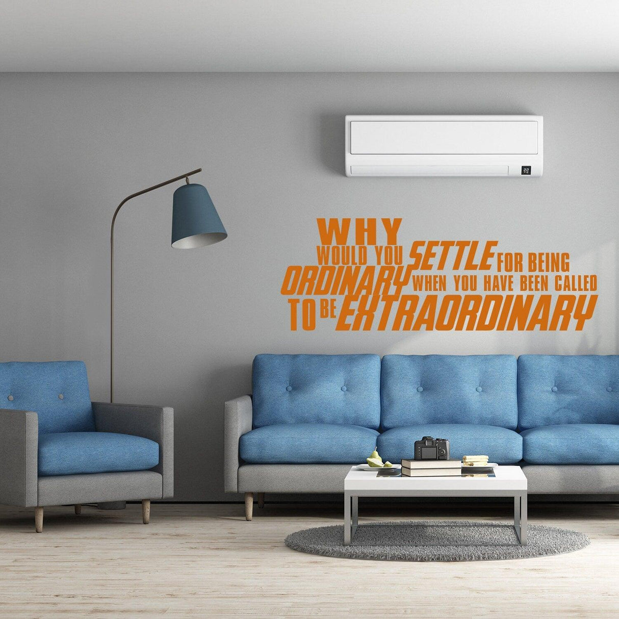 Inspirational wall vinyl quote sticker in modern living room with blue sofas and motivational message.