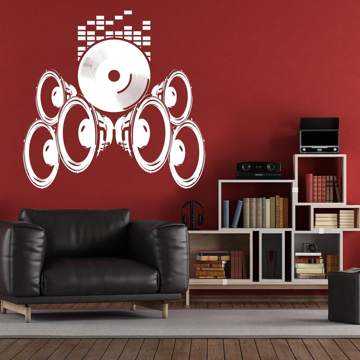Music speakers wall vinyl sticker on red wall above black couch, featuring retro design and creative decor.