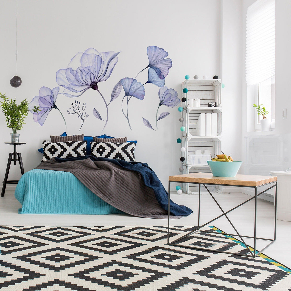 Living room featuring floral wall vinyl sticker mural of blue flowers, stylish bedding, and modern decor.