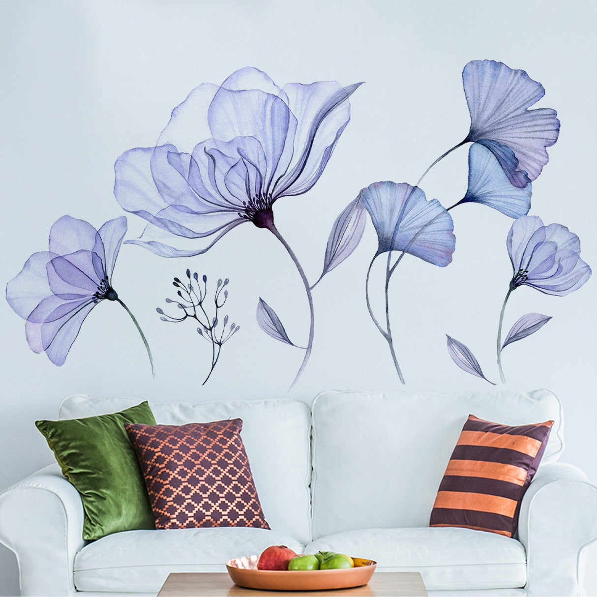 Floral wall vinyl sticker mural featuring blue 3D flowers above a cozy couch with decorative pillows.