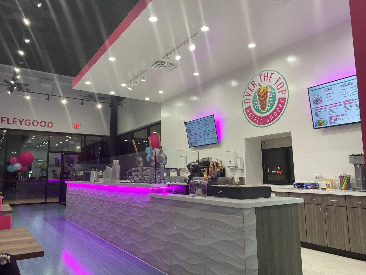 Interior view of Over the Top Ice Cream Shop with colorful decor and illuminated counter.