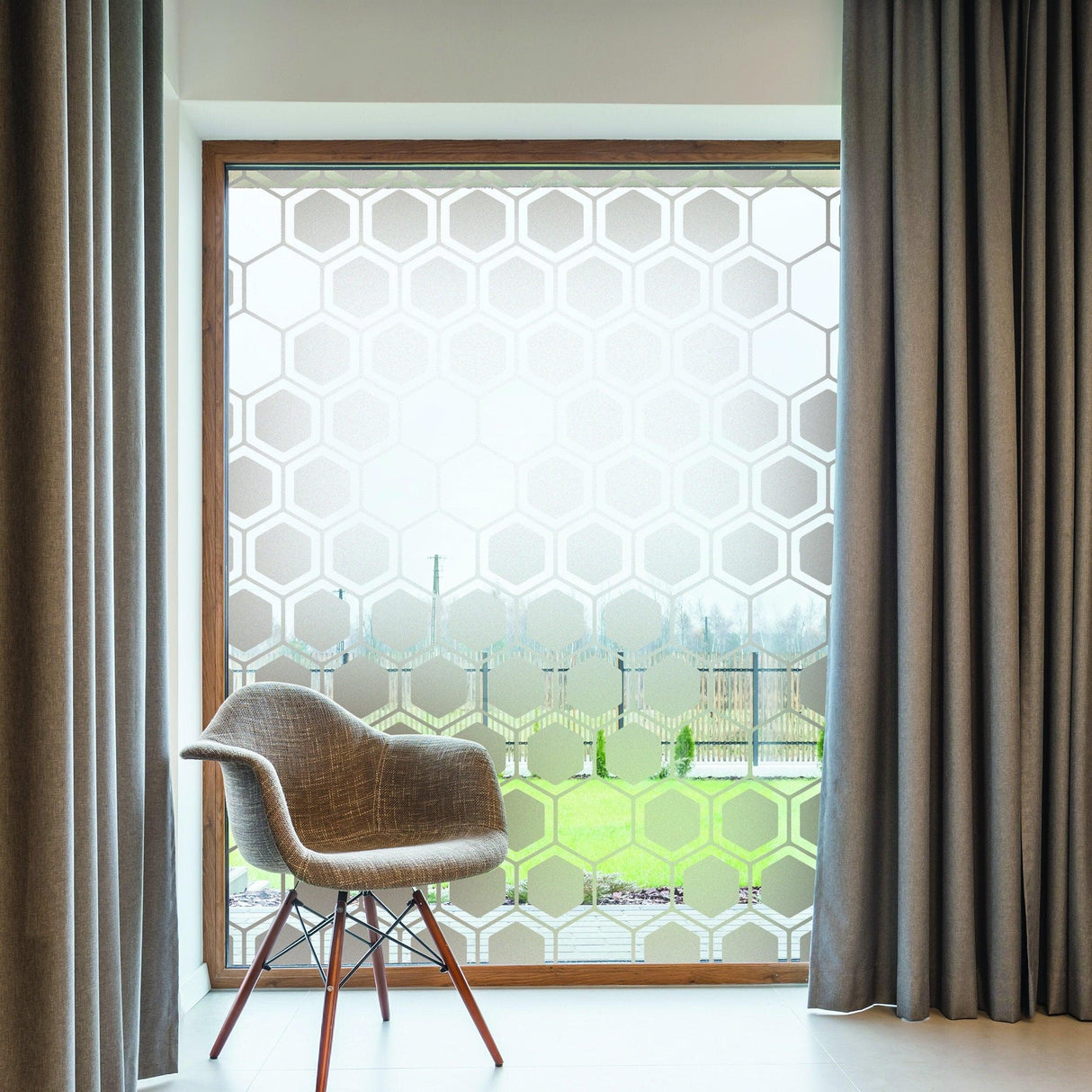 Frosted window decal with etched honeycomb design, enhancing privacy and style in a modern room setting.