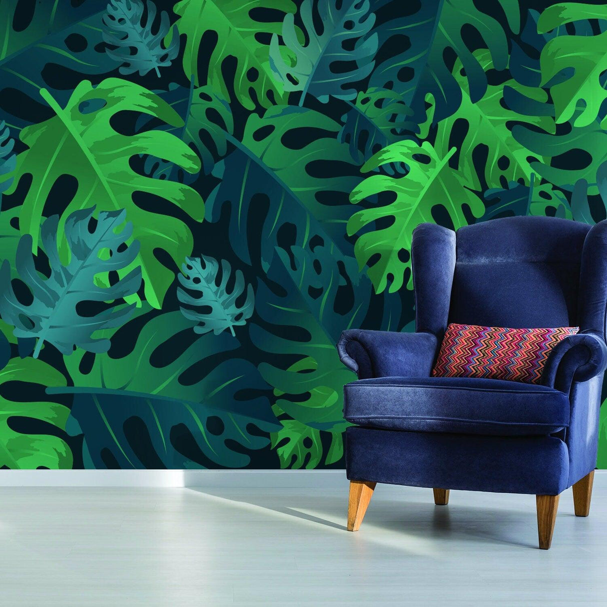 Vibrant green leaves wallpaper tapestry decor in a stylish room with a blue armchair and colorful cushion.