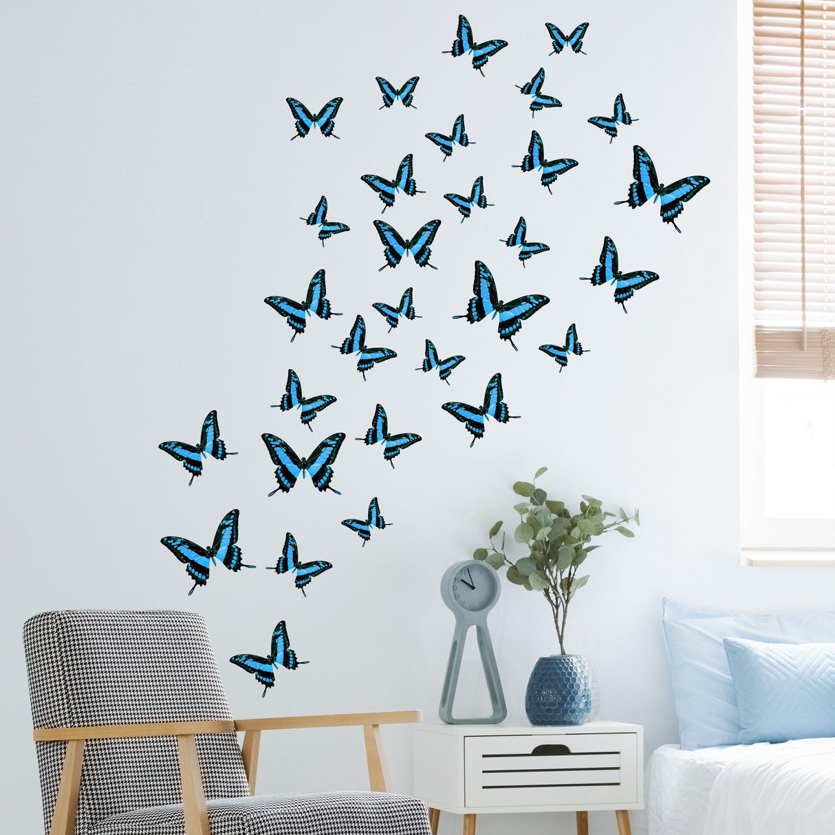 Decorative blue butterfly wall stickers arranged in a whimsical pattern, perfect for a girl's bedroom.