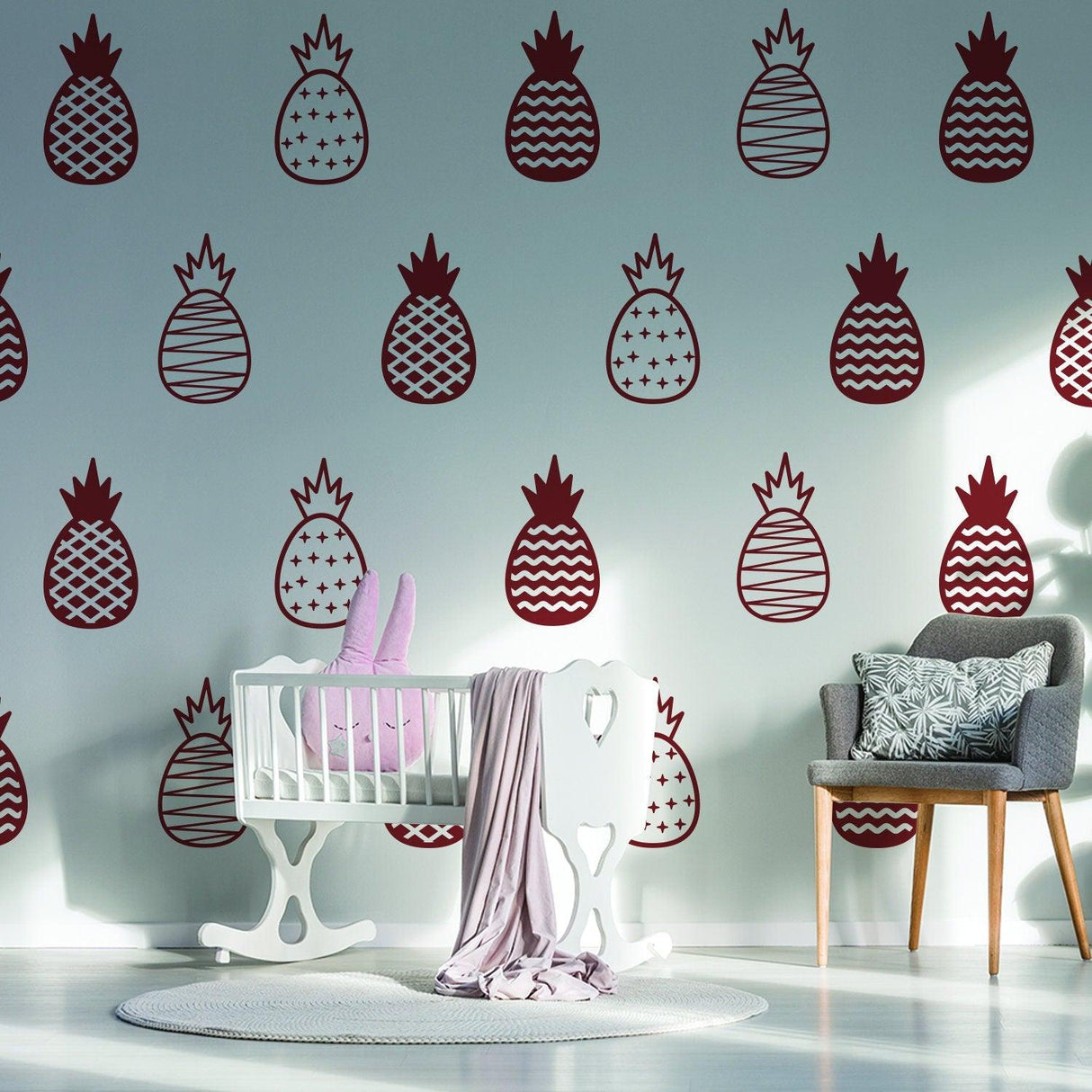 Gold pineapple wall decals in a bedroom with crib and stylish decor, adding playful elegance to the space.