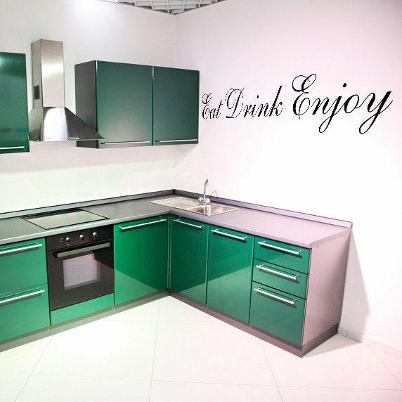 Stylish kitchen with green cabinets featuring 'Eat Drink Enjoy' vinyl quote wall sticker.
