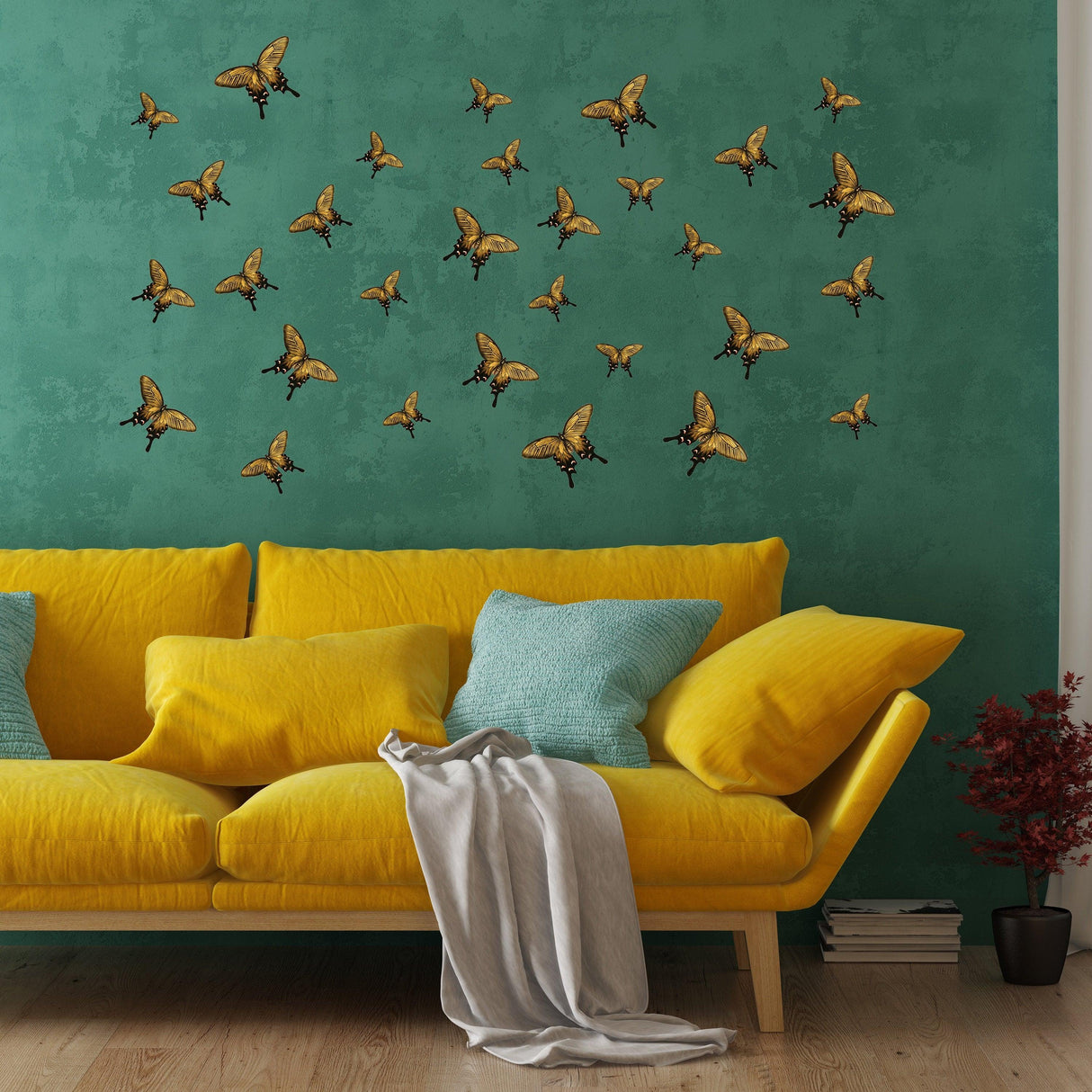 30 whimsical butterfly wall decor stickers in various sizes on a teal wall above a yellow sofa, perfect for girl bedroom decoration.