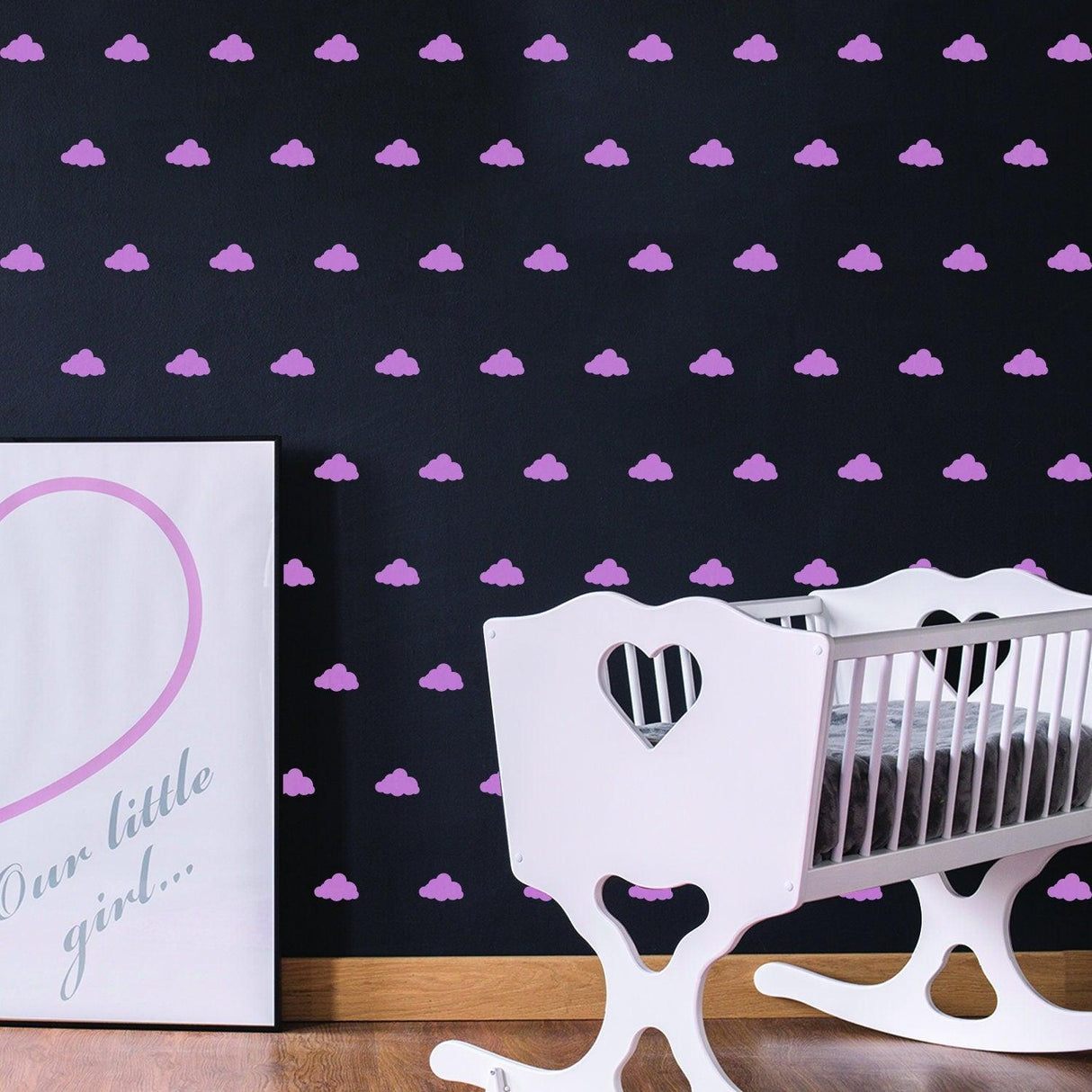 Purple cloud wall decals on black background in nursery with a white crib and wall art.