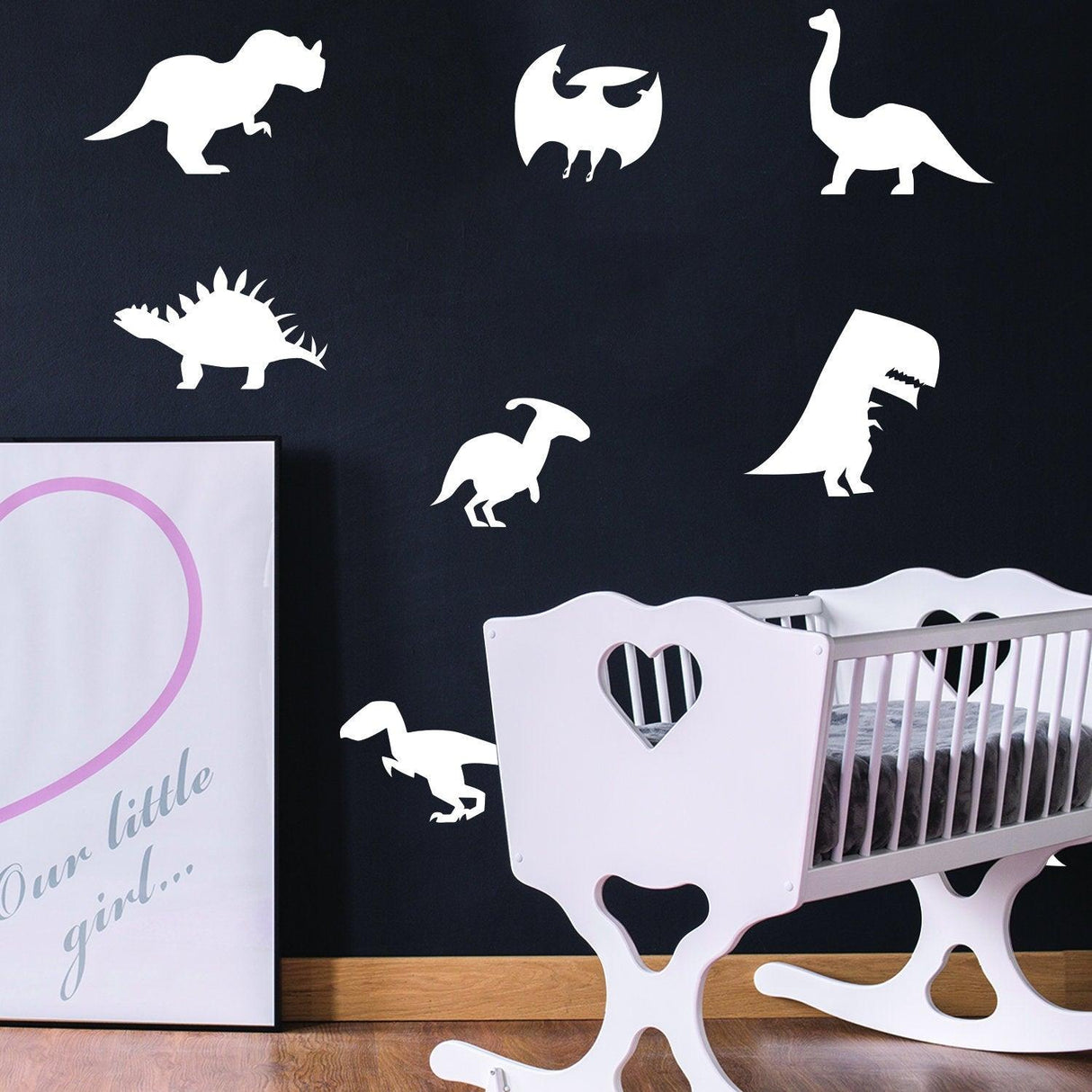 Glow in dark dinosaur wall decals on a black wall, featuring various dinosaur designs in a children's room.
