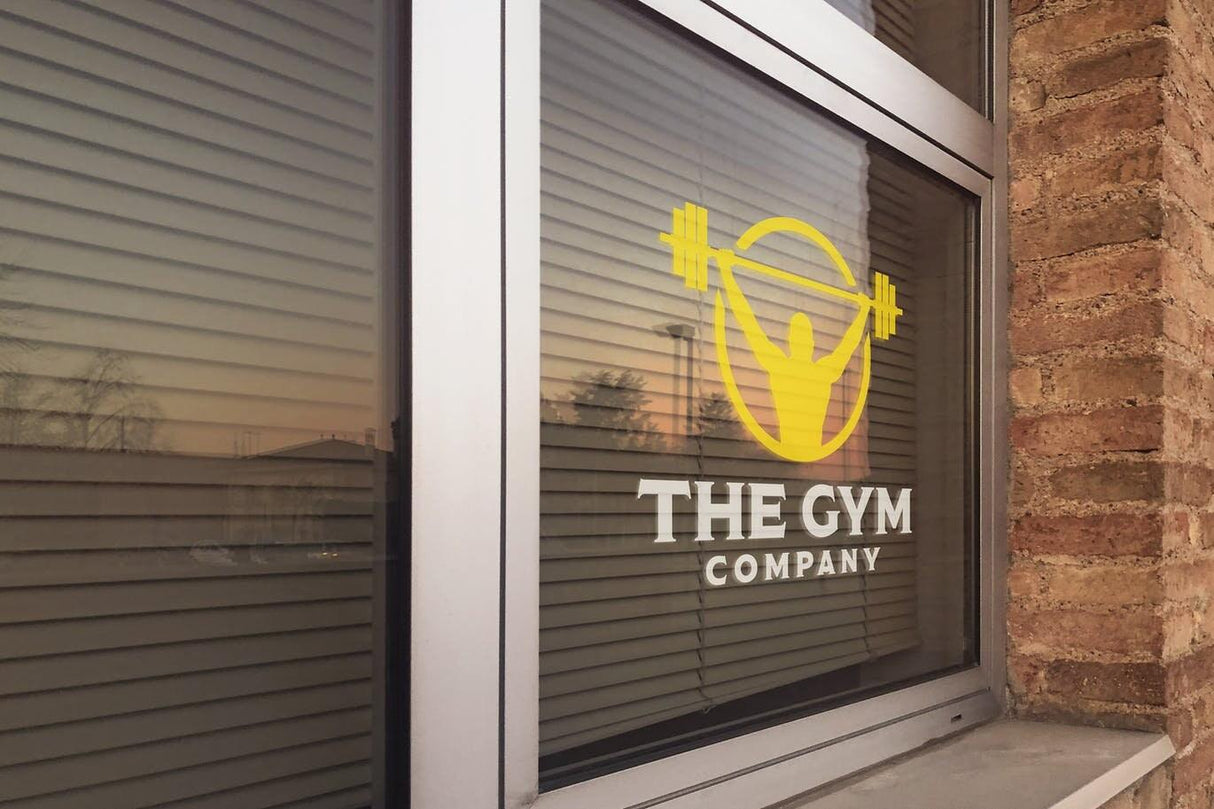 Custom static cling vinyl sticker for The Gym Company on window showcasing branding and fitness theme.