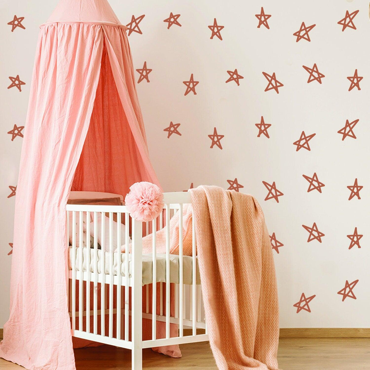 Elegant baby nursery featuring pink decor and star-shaped decals on the wall, ideal for a baby shower.