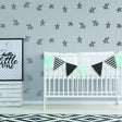 Baby nursery decorated with star stickers and a banner for a stylish baby shower theme.