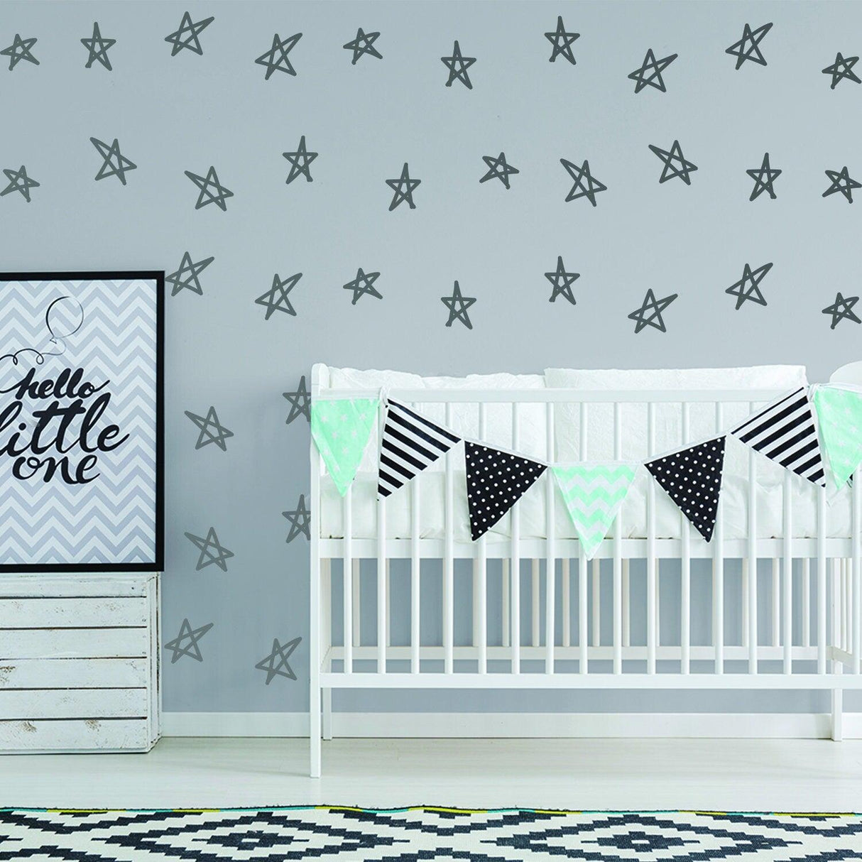 Baby nursery decorated with star stickers and a banner for a stylish baby shower theme.