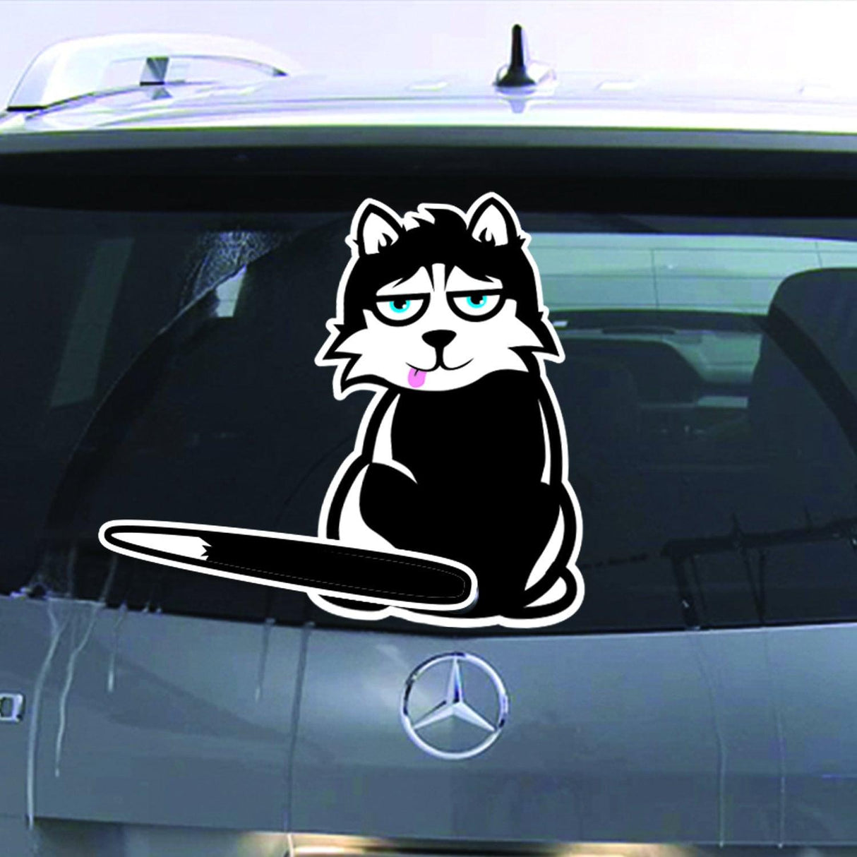 Cartoon cat decal on a car's rear windshield, adding personality and charm to vehicle decor.