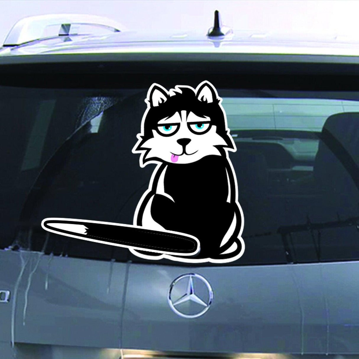 Cartoon cat vinyl decal on the rear window of a car, adding a fun touch to vehicle decor.