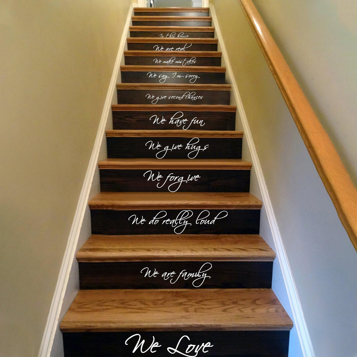 Staircase adorned with inspirational vinyl quote decals, showcasing messages about family and love.