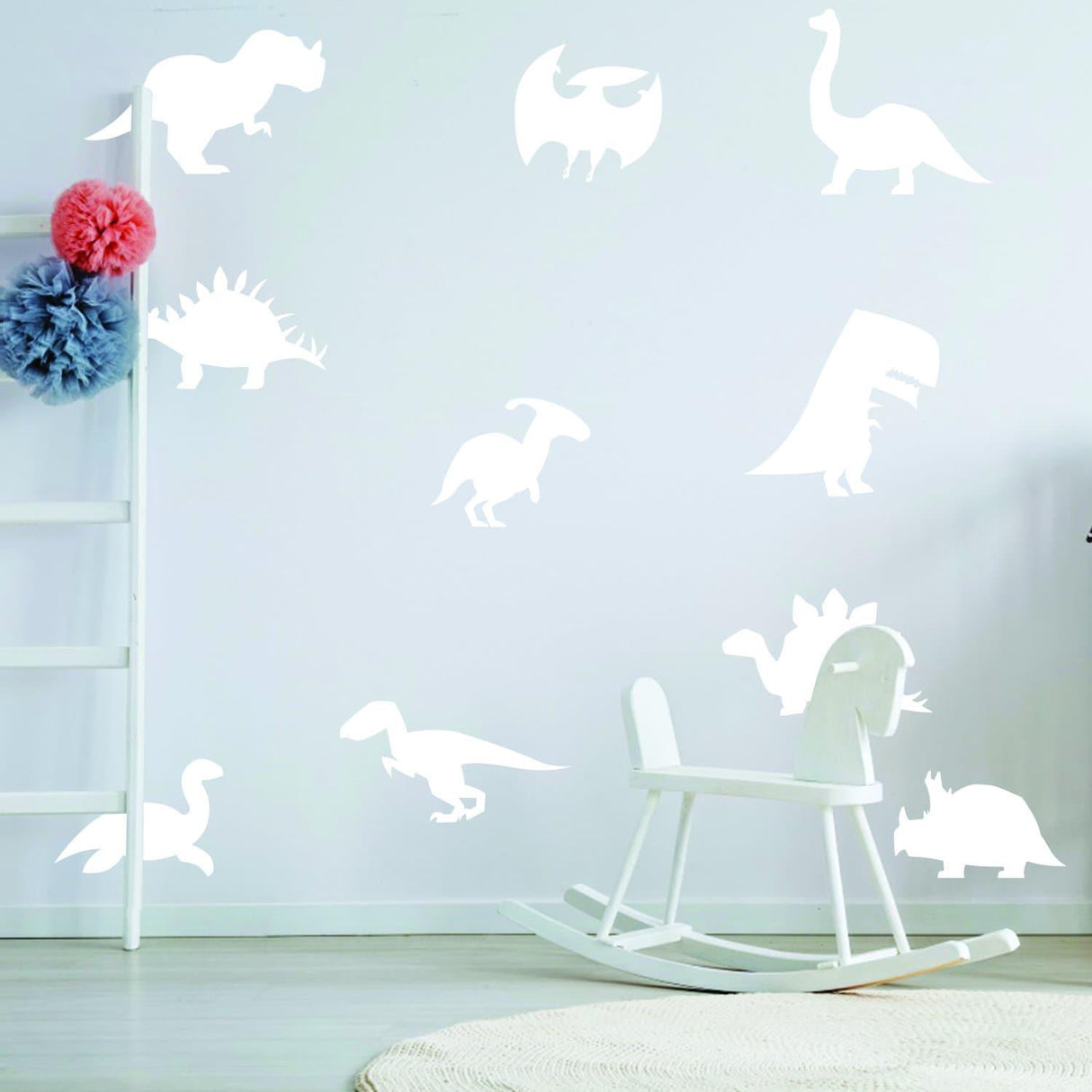 Glow in dark dinosaur wall decals in a child's room, featuring various dinosaur silhouettes on a white wall.