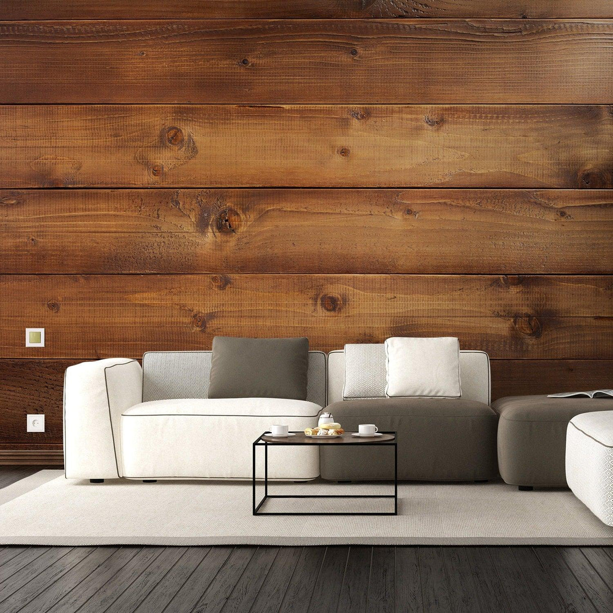 Modern living room with wood effect wall, featuring a cozy sofa, coffee table, and warm decor elements.