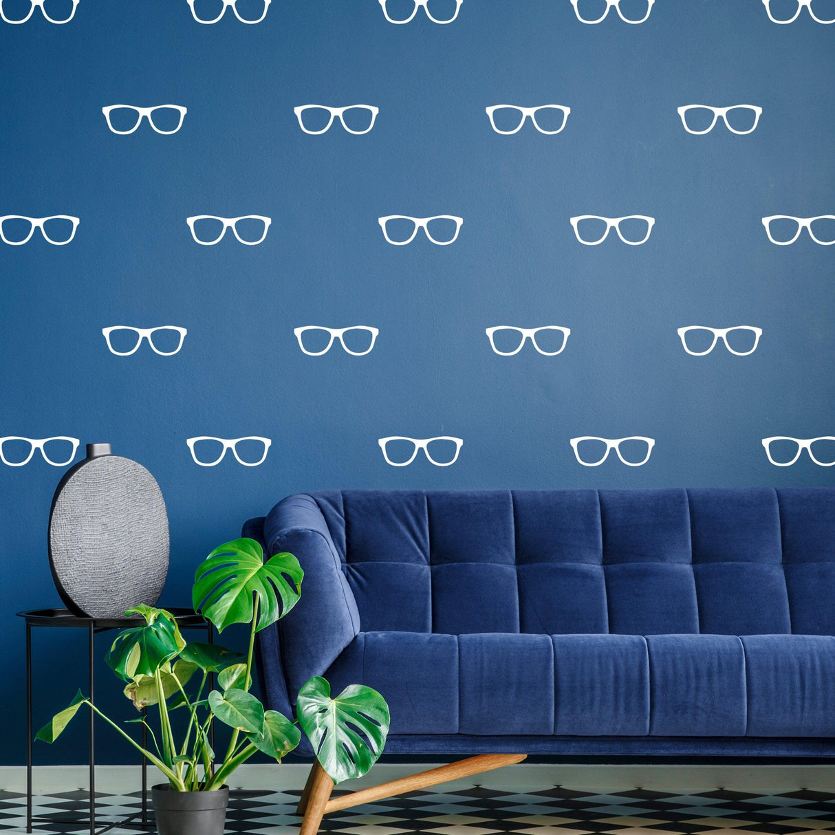 Stylish living room featuring 50x glasses wall decals on blue wall, accented by a modern blue couch and indoor plant.