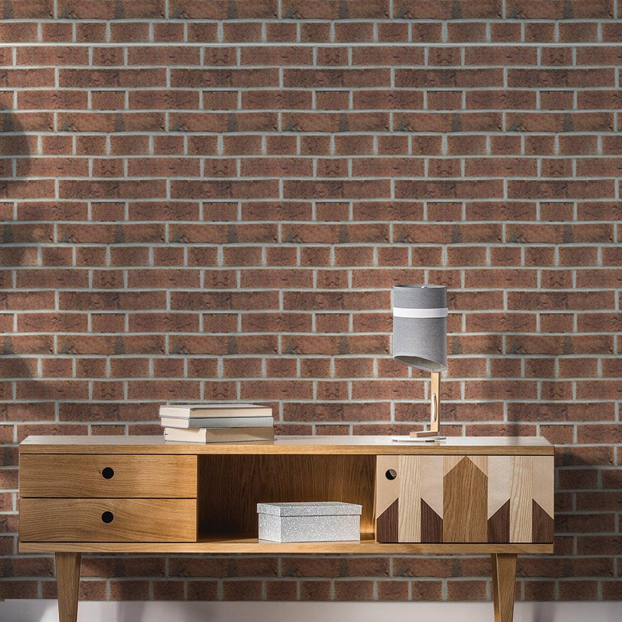 Brick self-adhesive wallpaper with a 3D stone effect on a living room wall behind a modern wooden console.