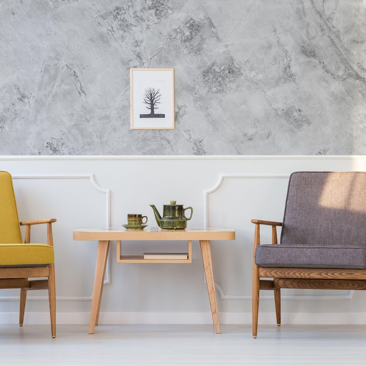 Stylish living room featuring marble vinyl wallpaper, wooden table, and two modern armchairs in elegant colors.