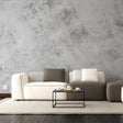 Elegant living room with marble vinyl wallpaper, modern furniture, and a cozy setup featuring a coffee table with cups.