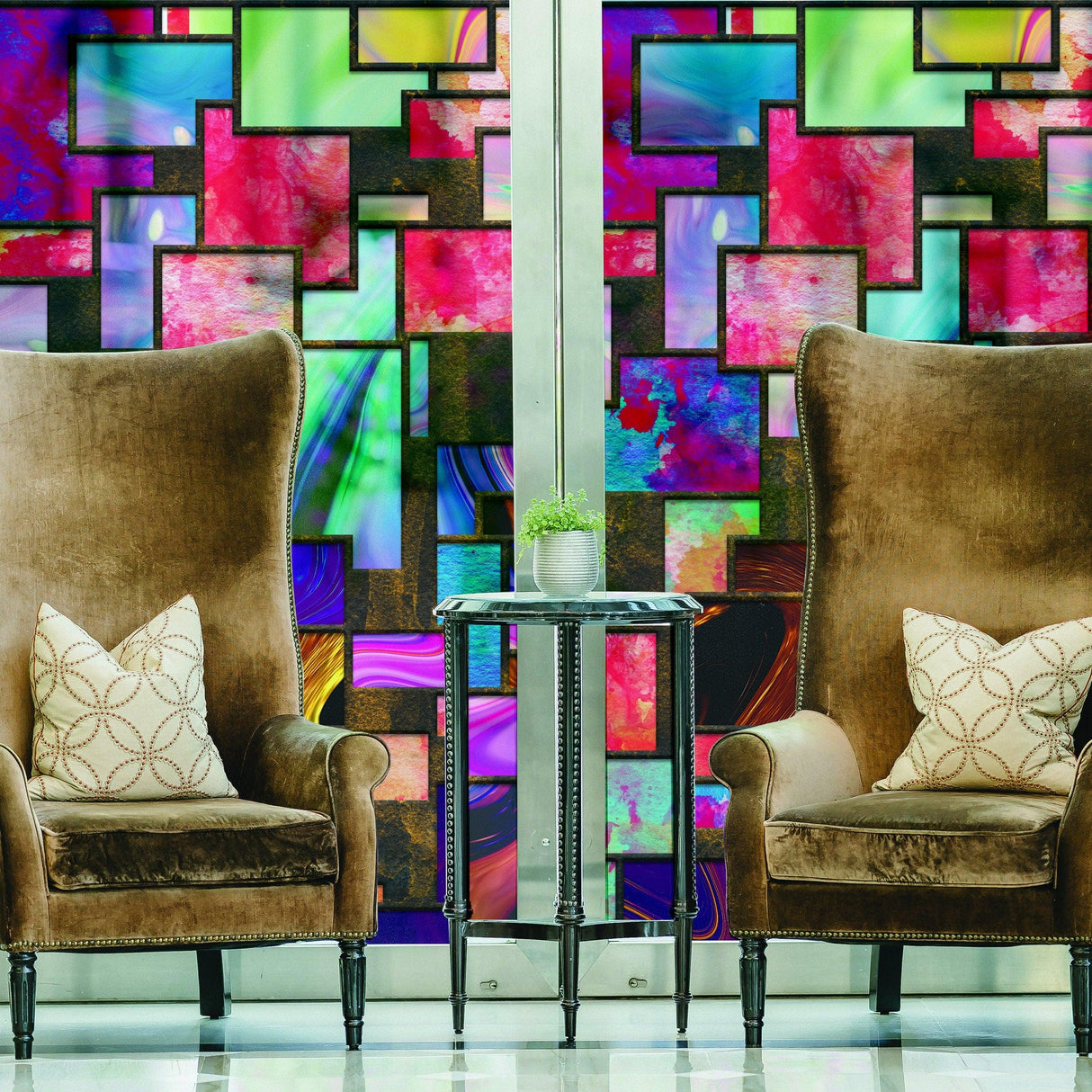 Vibrant decorative glass film behind elegant armchairs, adding color and privacy to a modern interior space.