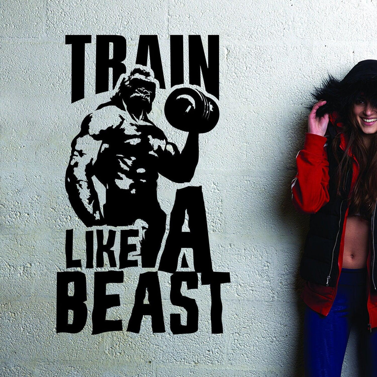 Fitness vinyl decal featuring a muscular figure and motivational quote 'Train Like A Beast' on a wall.