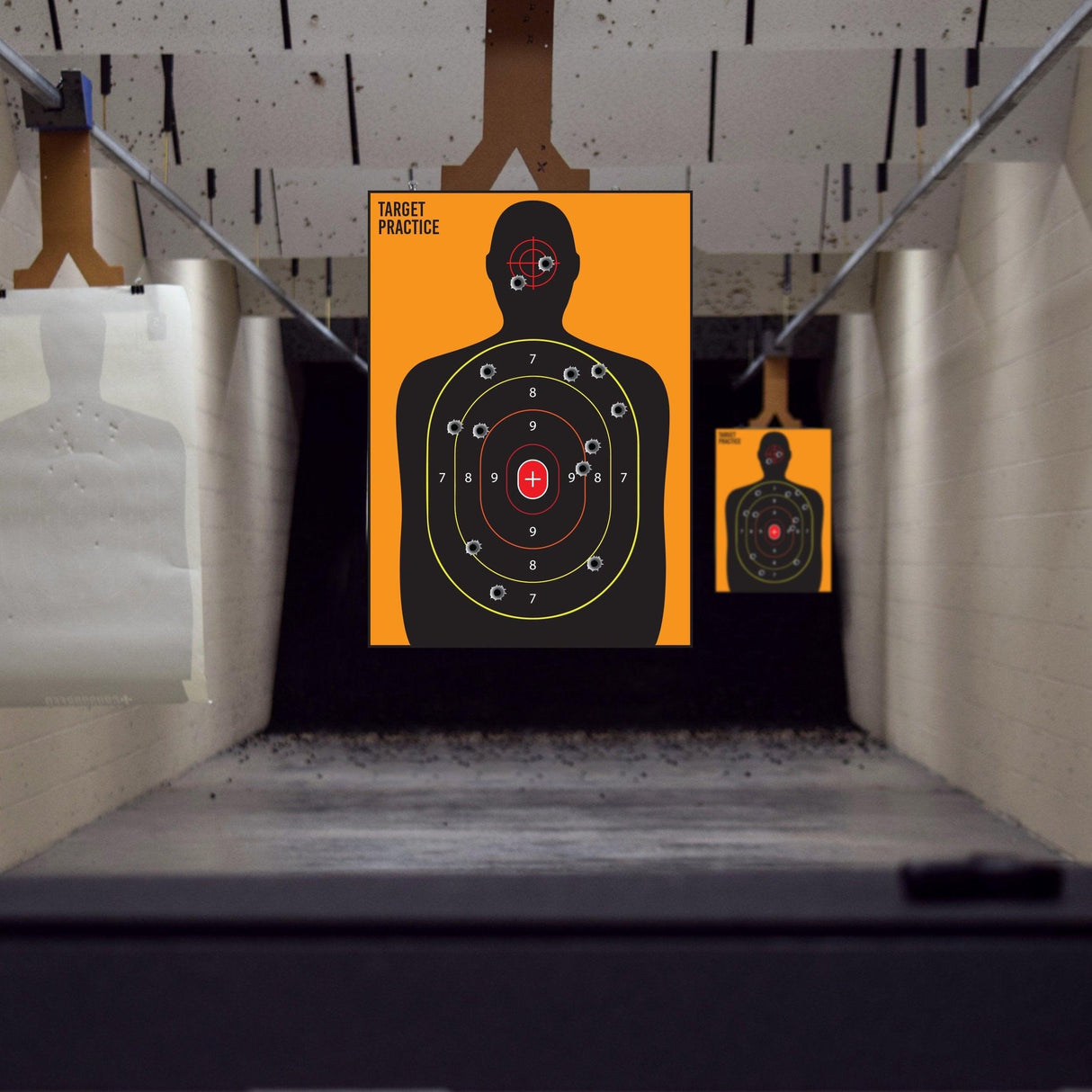 Large human silhouette shooting targets for practice in an indoor range setting.