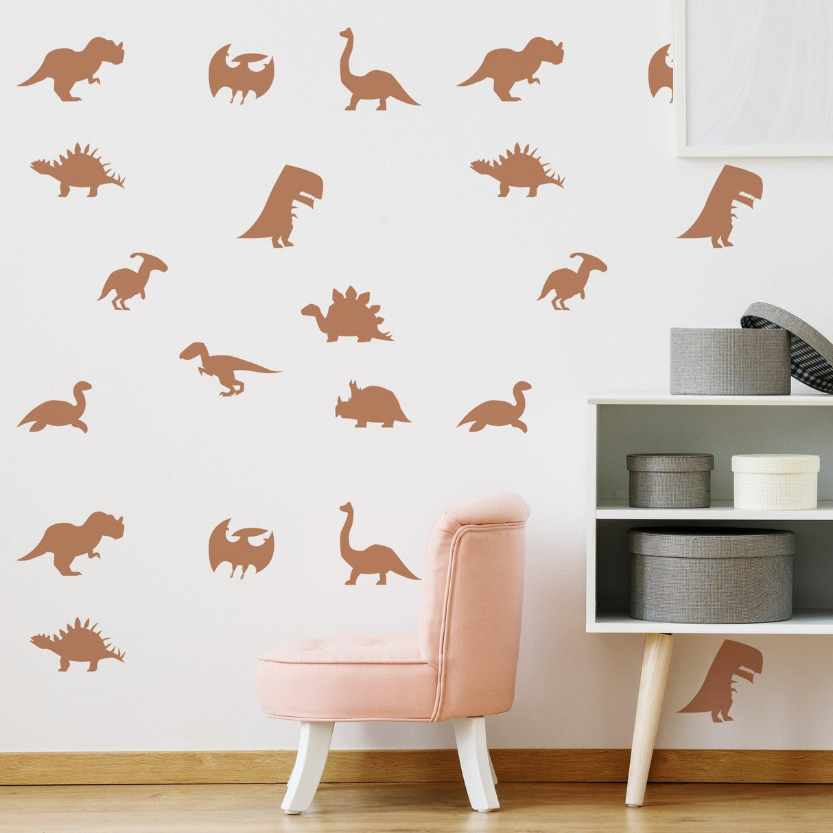 Dinosaur silhouette wall decals in a nursery, featuring various dinosaur shapes in a warm color scheme.