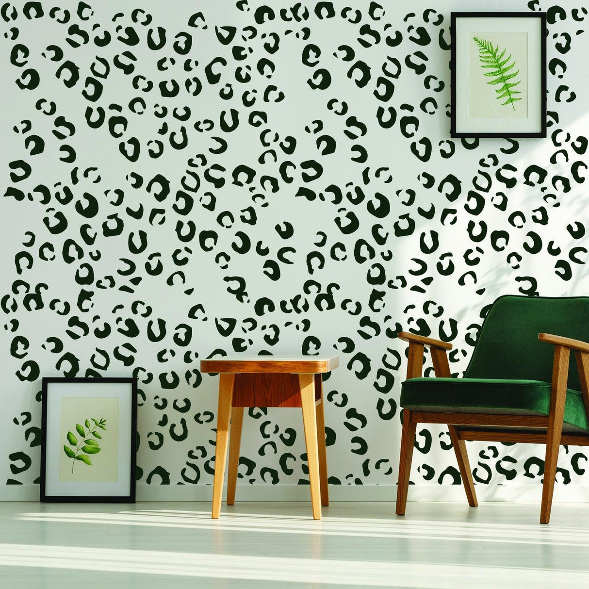 Leopard animal skin wall design with green accents, featuring framed botanical prints and a wooden table.