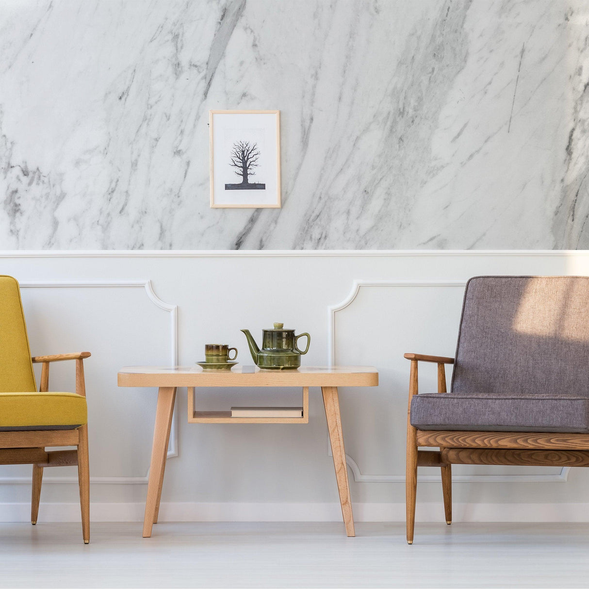 Stylish living room featuring marble vinyl wallpaper, modern wooden table, and colorful armchairs.