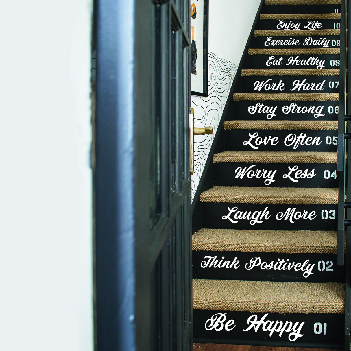 Vinyl decals on staircase featuring motivational quotes like 'Be Happy' and 'Stay Strong' for home decor.