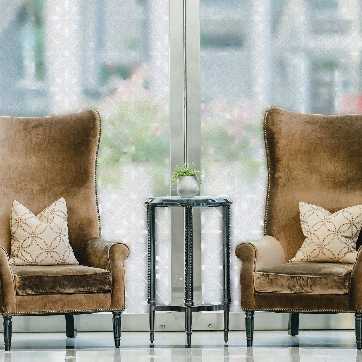 Cozy seating area with elegant chairs and decorative pillows, enhanced by frosted window decal for privacy.