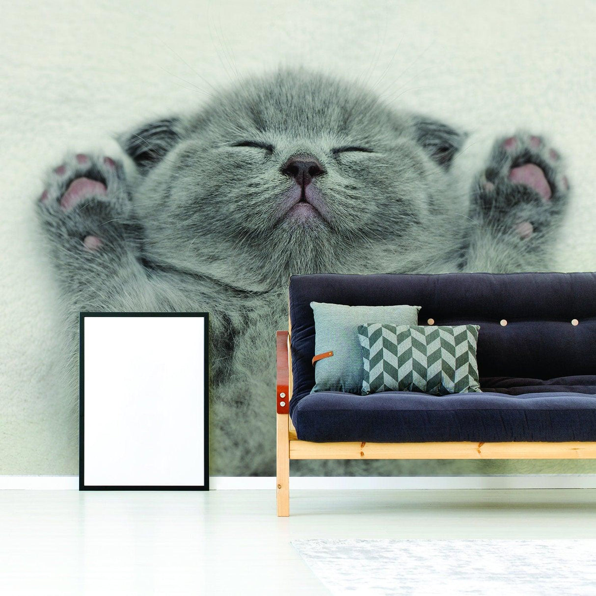 Gray kitten vinyl wall decal above a modern couch, perfect for home decor lovers.