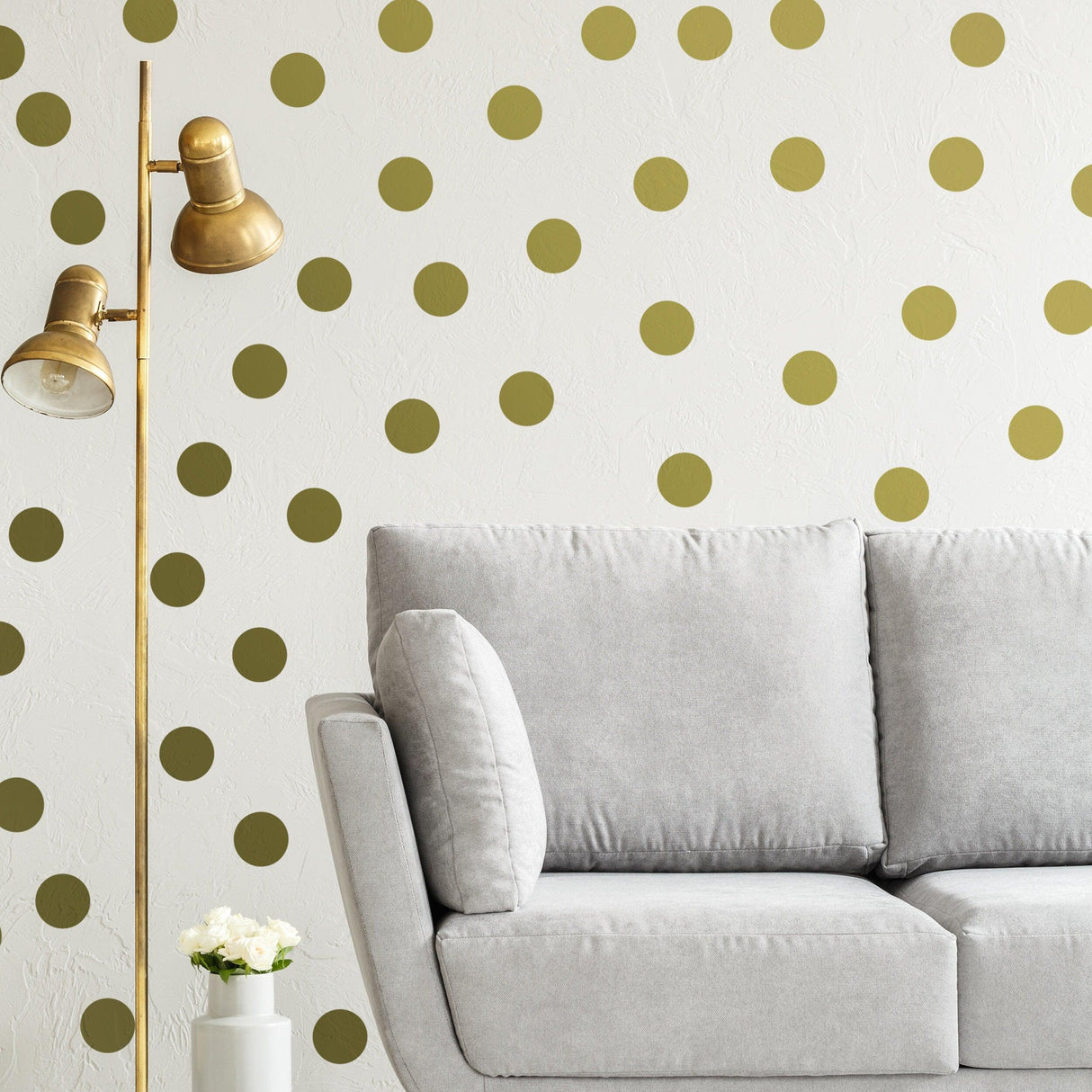 Stylish room featuring gold circle wall stickers and a gray sofa with a gold floor lamp.