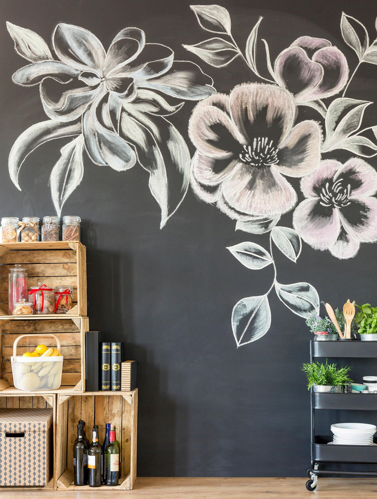 Stylish chalkboard wall sticker with floral designs, enhancing kitchen decor with crates and cart.