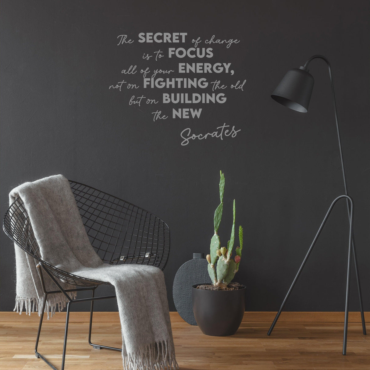 Inspirational wall decor sticker featuring Socrates quote on a black wall with modern chair and plants in stylish living space.