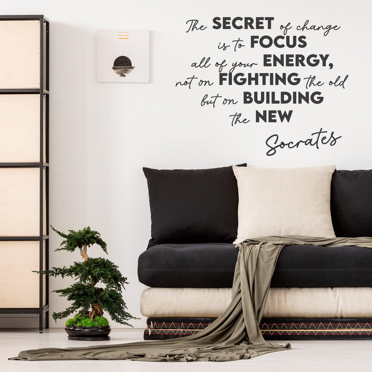 Inspirational wall decal with Socrates quote on change, decor for living room featuring modern couch and plant.